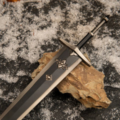 Close-up macro detail of the Greatsword of Solitude's hilt and the silver cross emblems on the dark grey blade.