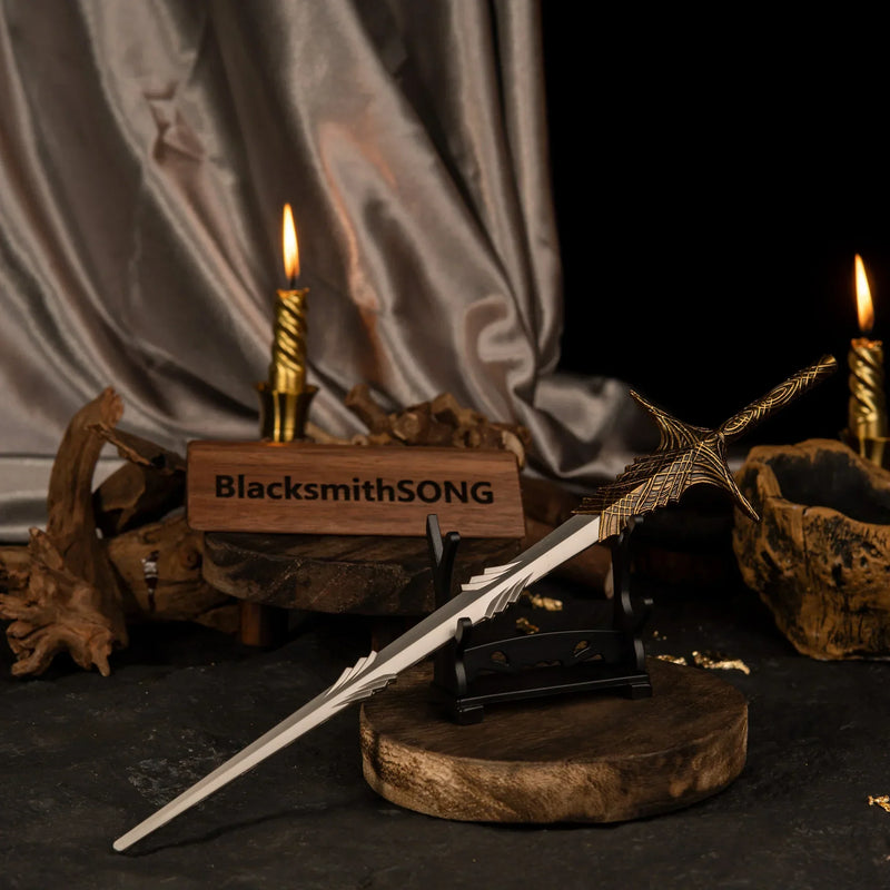 Leda's Sword miniature resting on a small wooden horizontal stand against a backdrop of draped fabric and candlelight.