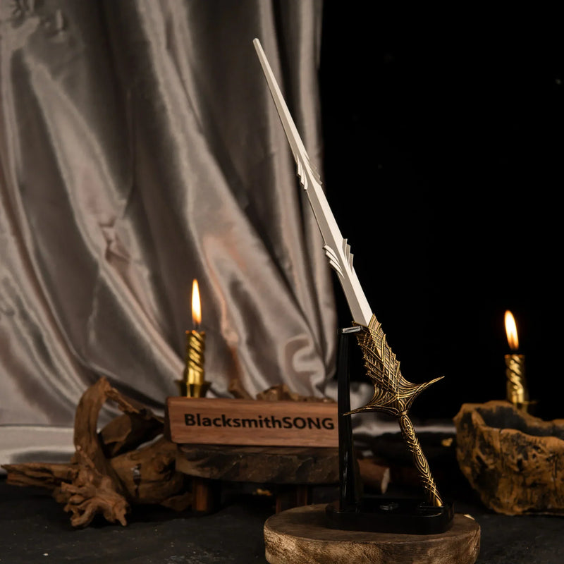 Vertical display of the Leda's Sword replica on an upright black stand, illuminated by a nearby lit candle and draped silk.