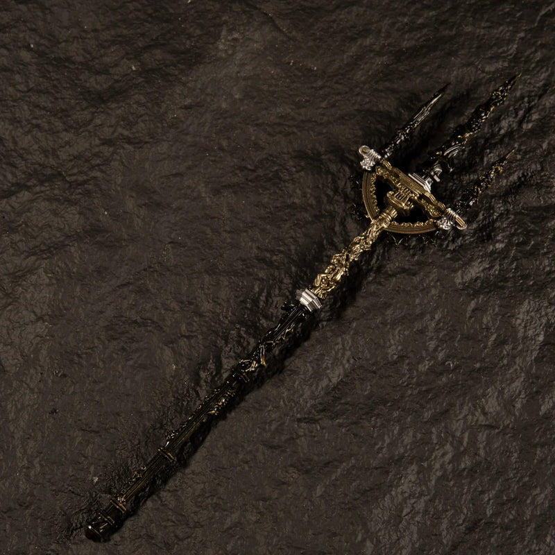 Angled view of the Mohgwyn's Sacred Spear metal miniature showing the intricate baroque engravings on the shaft, isolated on a black background.