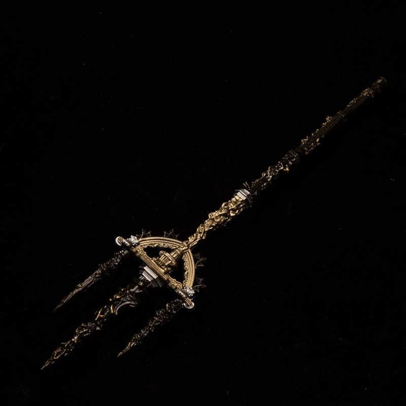 Solid metal replica of Mohgwyn's Sacred Spear from Elden Ring with three ornate gold and black prongs, isolated on a clean black background.