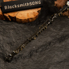 Close-up detail of the textured handle and antique gold crossguard of the Mohgwyn's Sacred Spear metal miniature weapon.