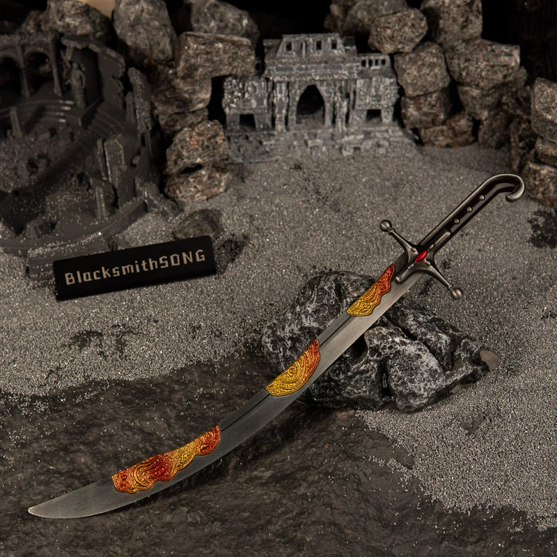 Wide angle view of the Nomad's Kilij metal miniature lying diagonally across dark rocks in a ruined temple setting with a BlacksmithSONG sign.
