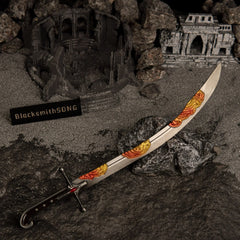 Nomad's Kilij curved sword metal replica resting on a dark rock, surrounded by grey ash-like sand and a miniature ruined colosseum diorama.