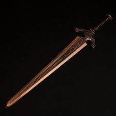 Solid metal replica of Ordovis's Greatsword from Elden Ring, featuring a red-tinged gold finish, isolated on a black background.