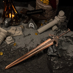 Ordovis's Greatsword metal replica resting on dark rocks, surrounded by grey sand, broken classical pillars, rune stones, and a miniature bonfire.