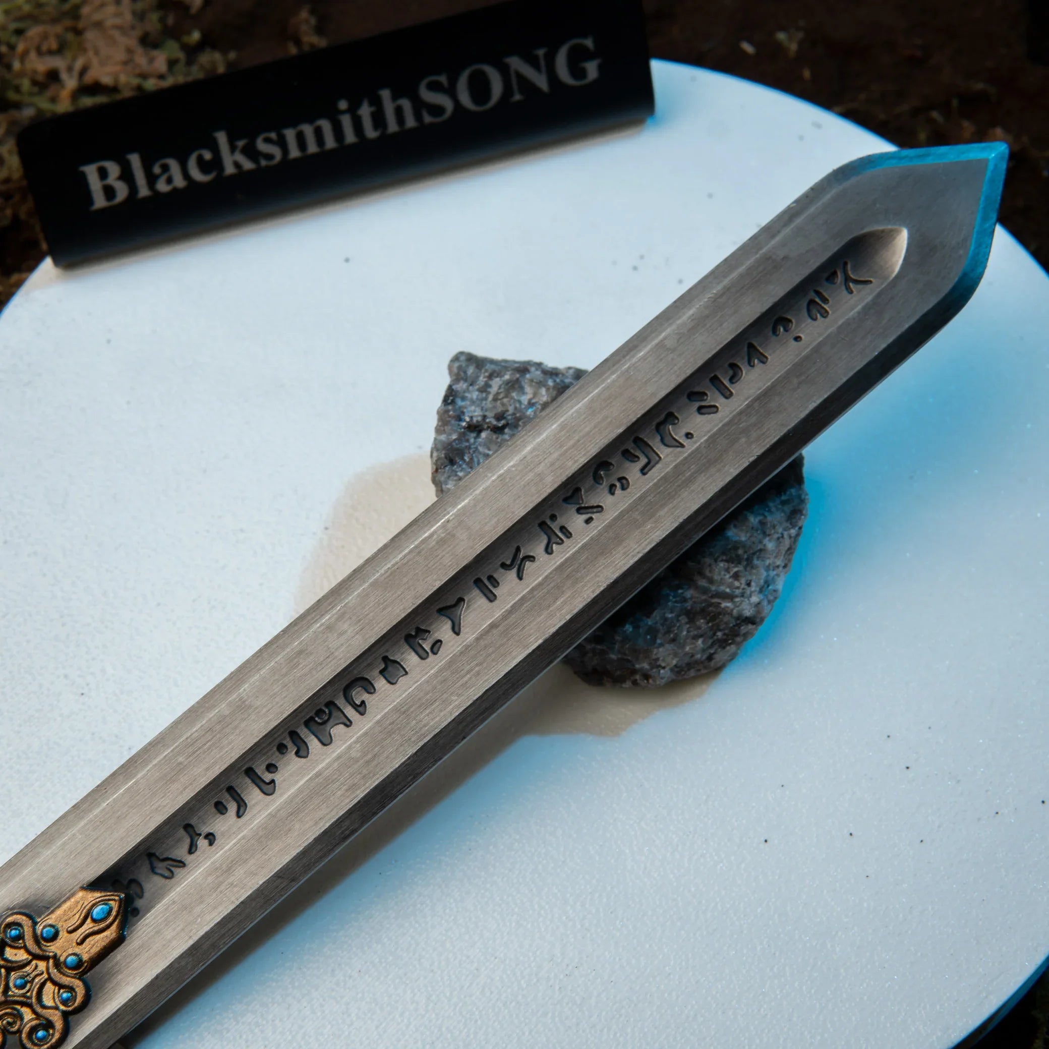 Royal Greatsword replica — cast script running down the blade fuller, close-up.