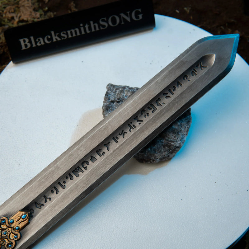 Royal Greatsword replica — cast script running down the blade fuller, close-up.