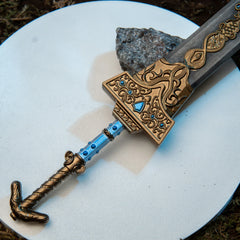 Royal Greatsword replica — gold Carian crossguard and blue-set grip, close-up.