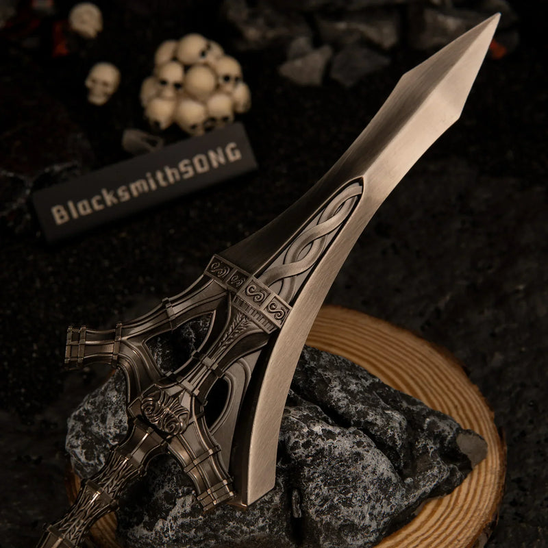 Macro close-up shot of the wide metallic blade and ornate crossguard of the Serpent-Hunter metal replica.
