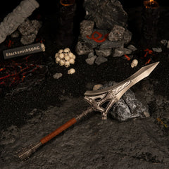 Angled view of the Serpent-Hunter metal spear in a diorama featuring glowing magma rocks and a stone with a red serpent rune.
