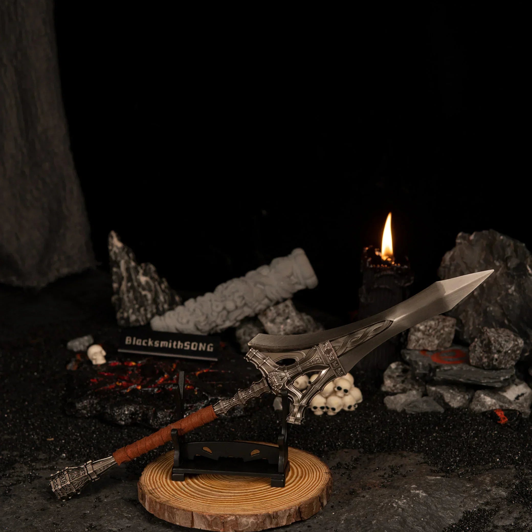 Serpent-Hunter miniature resting on a small horizontal stand with a wooden base, surrounded by dark rocks and a lit black candle.