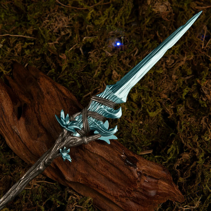 Macro close-up shot of the icy blue glintstone-style spearhead and the upper twisted handle of the Spear of the Dreaming metal miniature.