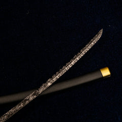 Detailed view of the metallic blade of the Star Shadow miniature sword, showcasing swirling, Damascus-style patterns.