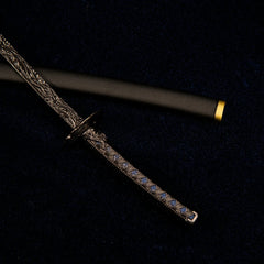 Macro close-up shot of the dark blue diamond-patterned handle and circular handguard of the Star Shadow katana replica.
