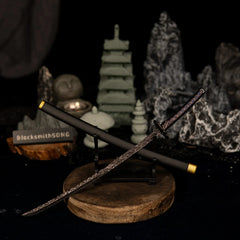 Star Shadow miniature resting on a small horizontal stand with a wooden base, surrounded by dark rocks and a lit candle.