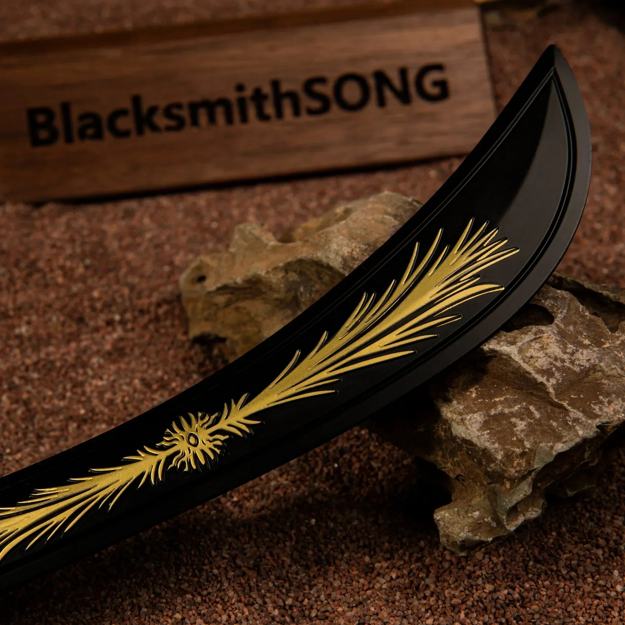 Detailed close-up view of the matte black curved blade of the Starscourge Greatsword miniature, featuring the iconic golden gravity crest pattern.