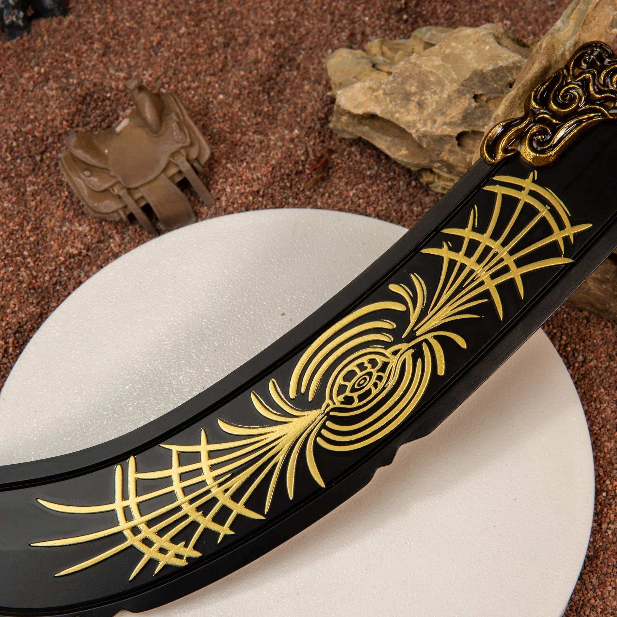 Detailed view of the curved matte black blade of the zinc alloy Starscourge Greatsword replica resting on rocks.
