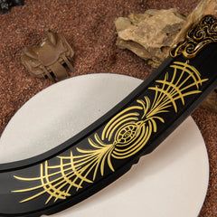 Detailed view of the curved matte black blade of the zinc alloy Starscourge Greatsword replica resting on rocks.
