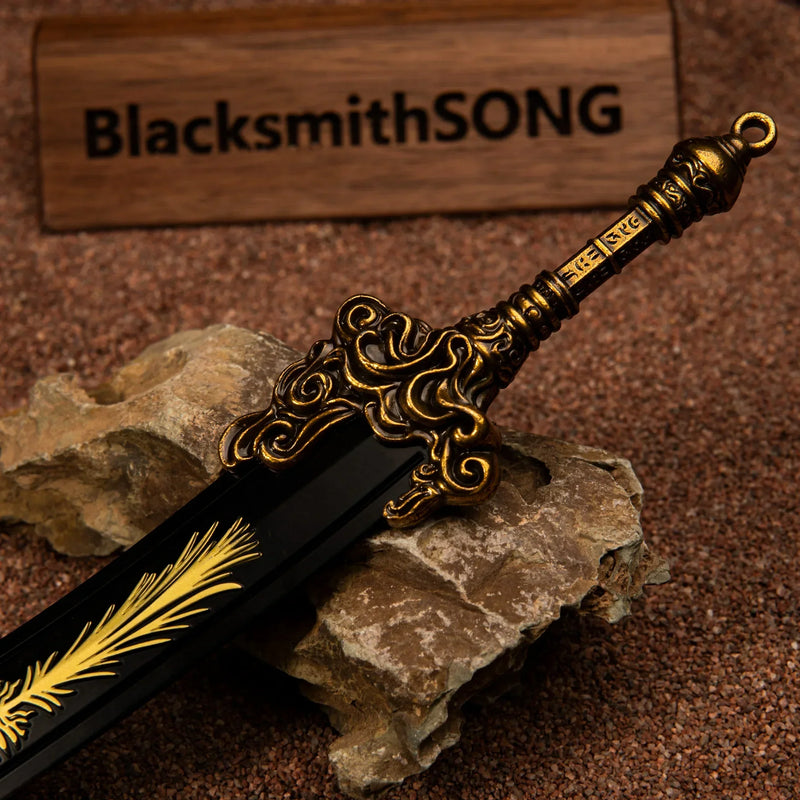 Macro close-up shot of the ornate gold-colored hilt and crossguard of the Starscourge Greatsword metal replica.