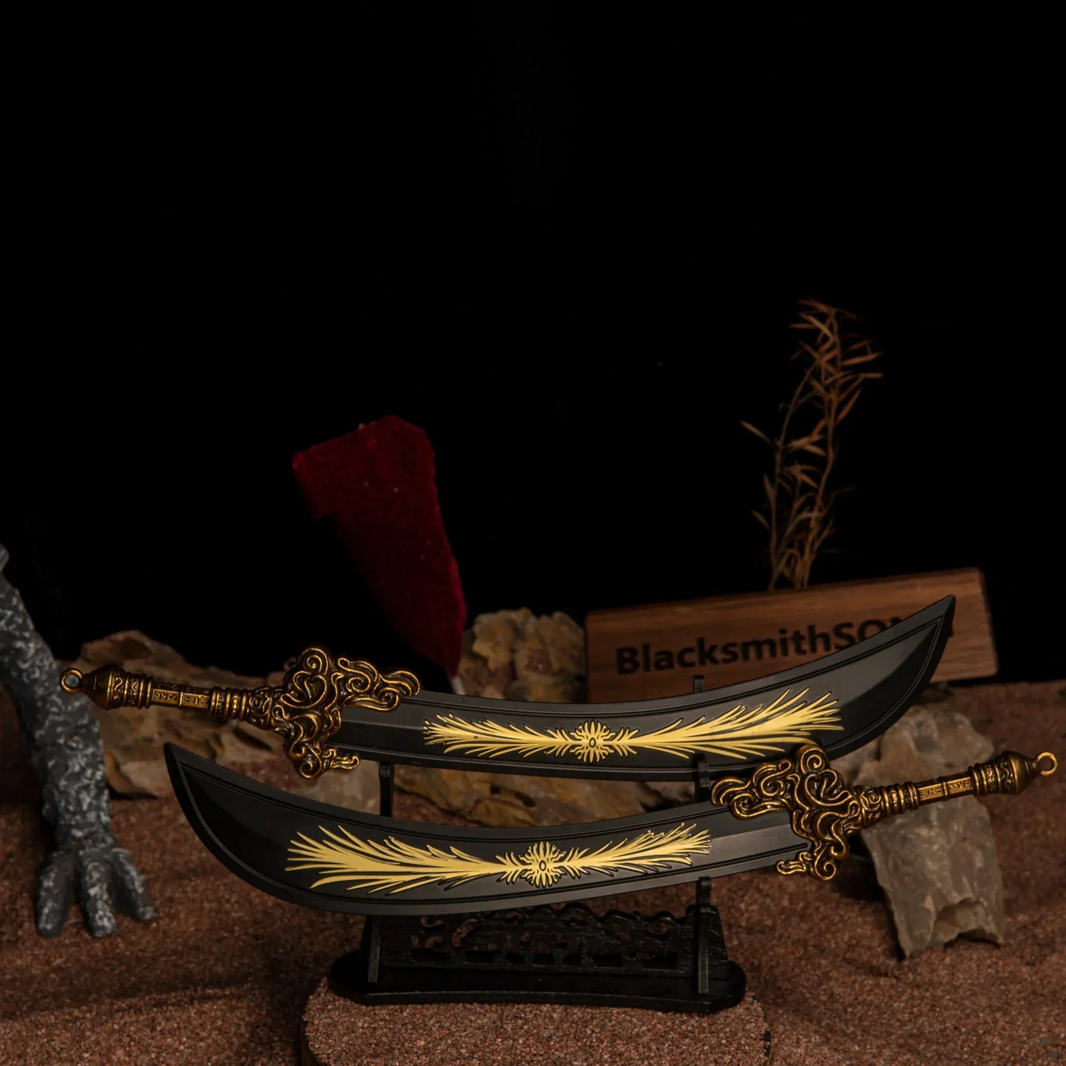 Two Starscourge Greatsword metal replicas displayed parallel to each other on a large black decorative stand over red sand.