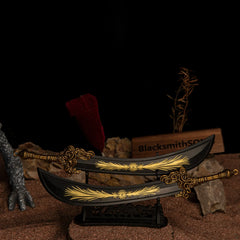 Two Starscourge Greatsword metal replicas displayed parallel to each other on a large black decorative stand over red sand.