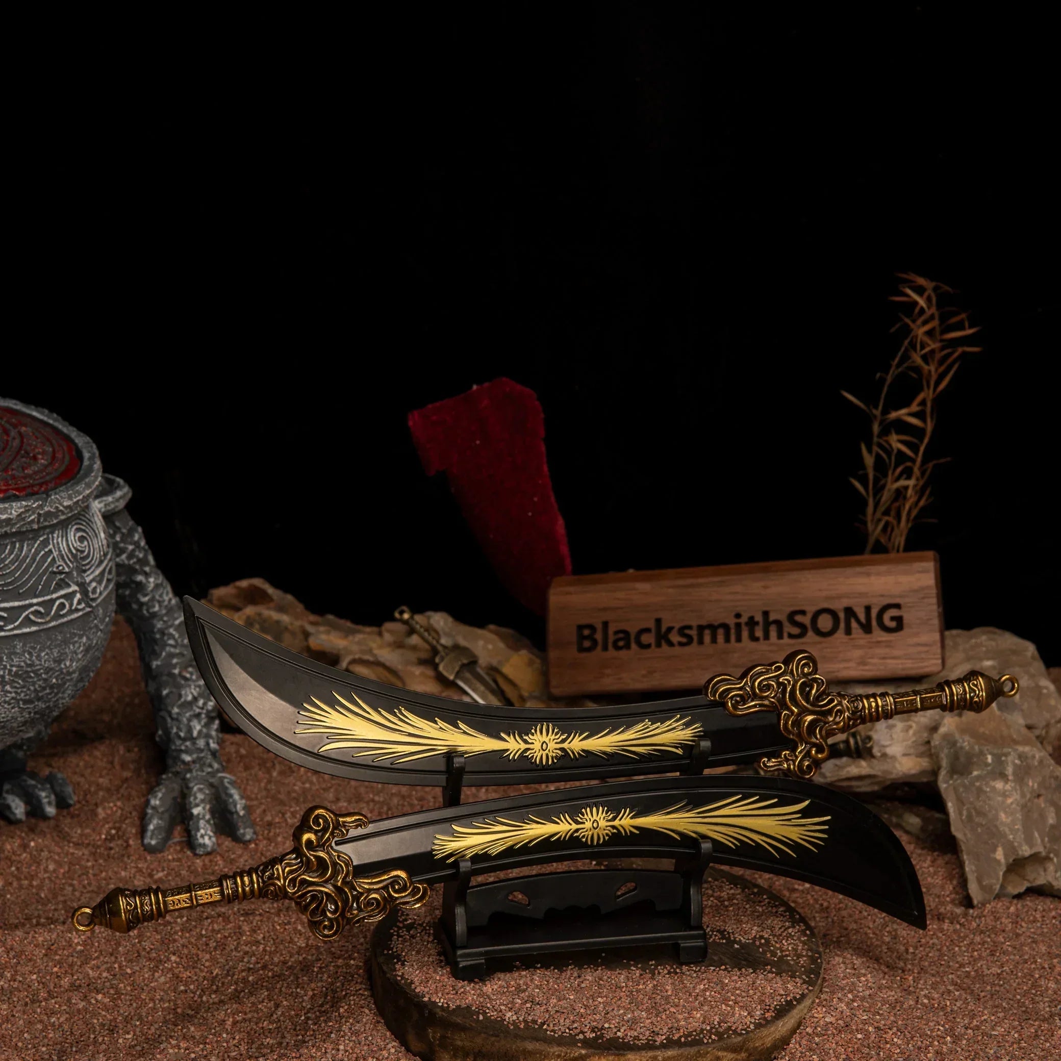 Starscourge Greatsword metal replicas displayed parallel on a small black stand, resting on red sand with rocks and a clawed statue in the background.