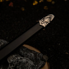 Blackfyre replica — sculpted silver fitting at the scabbard tip, close-up.