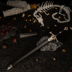 Blackfyre replica — sheathed in its black scabbard among gold coins and dragon bones.
