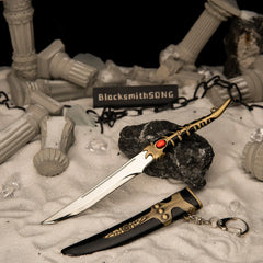 Catspaw Dagger replica (18cm die-cast zinc alloy dagger) — hero shot beside its scabbard in a ruined-columns snow diorama, by BlacksmithSONG.