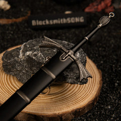 Dark Sister replica — winged crossguard and hilt detail on a wood round.