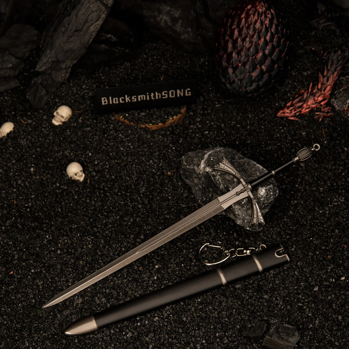 Dark Sister metal sword replica unsheathed on black volcanic sand, surrounded by mini skulls and a dragon egg prop.