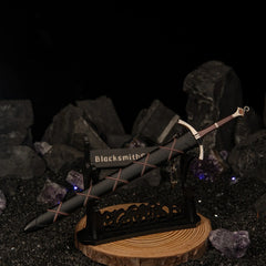 Dawn Sword replica — displayed flat on the large stand over a dark stone set.