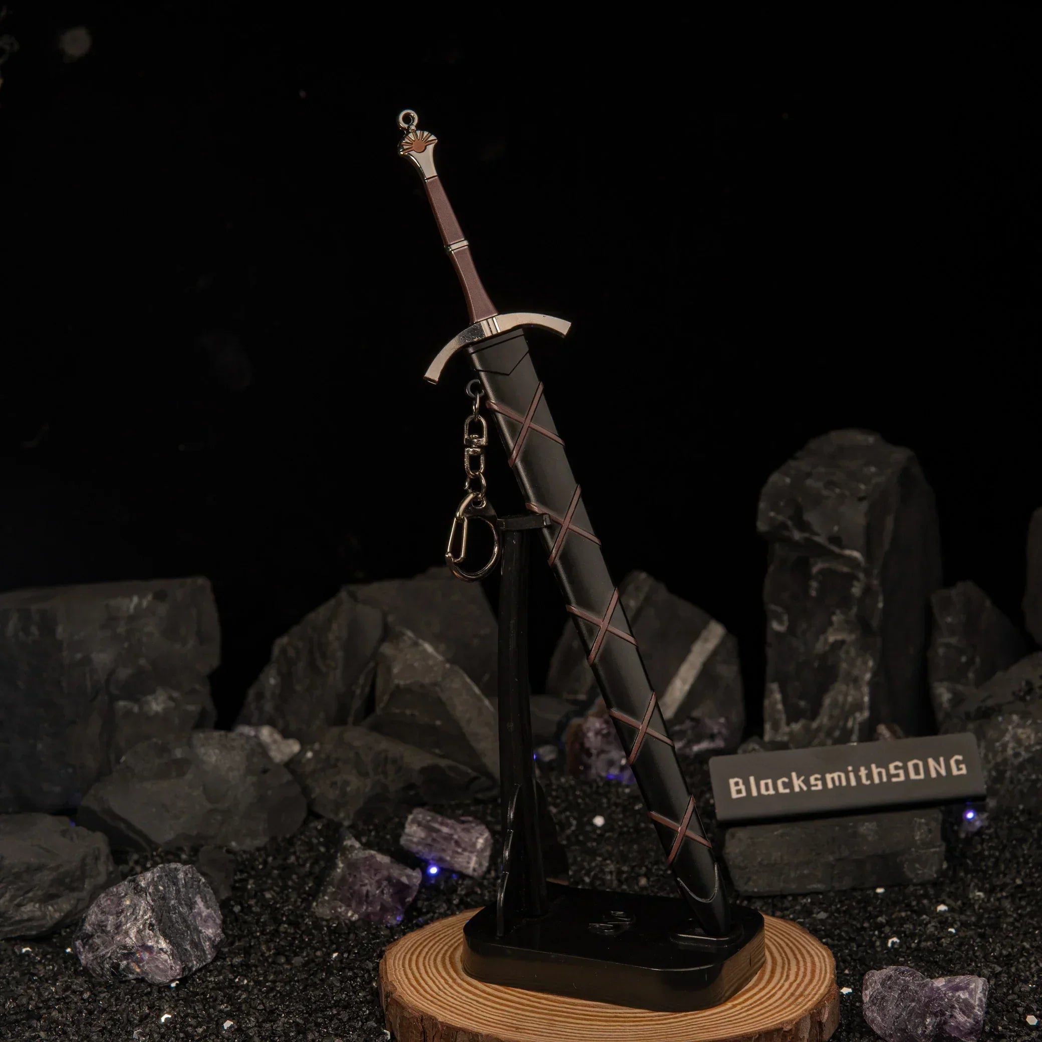 Dawn sword replica standing vertically on a custom display base, surrounded by dark rocks and crystals.