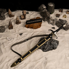 Longclaw replica — drawn beside its scabbard in a handcrafted snow village diorama.
