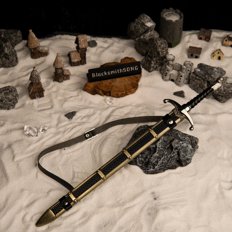 Longclaw replica — drawn beside its scabbard in a handcrafted snow village diorama.
