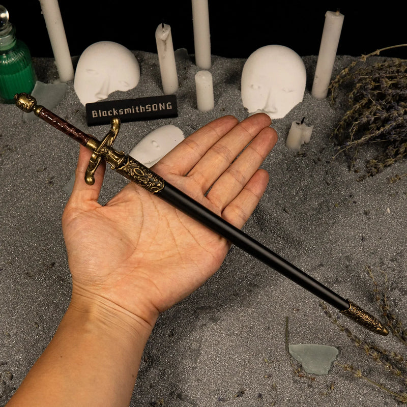 Needle replica (30cm die-cast zinc alloy sword) — held in hand for scale.