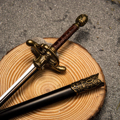 Needle replica — filigree guard and pressed red grip on a wood round.