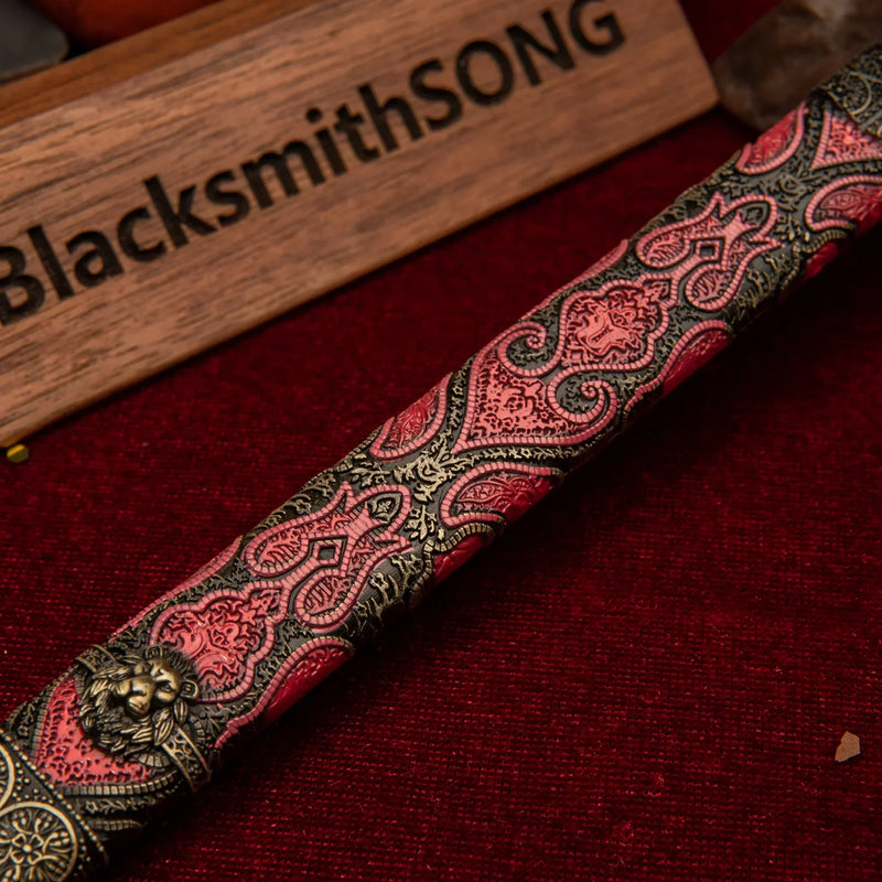 Oathkeeper replica — red-and-gold scabbard laid across a wood round.