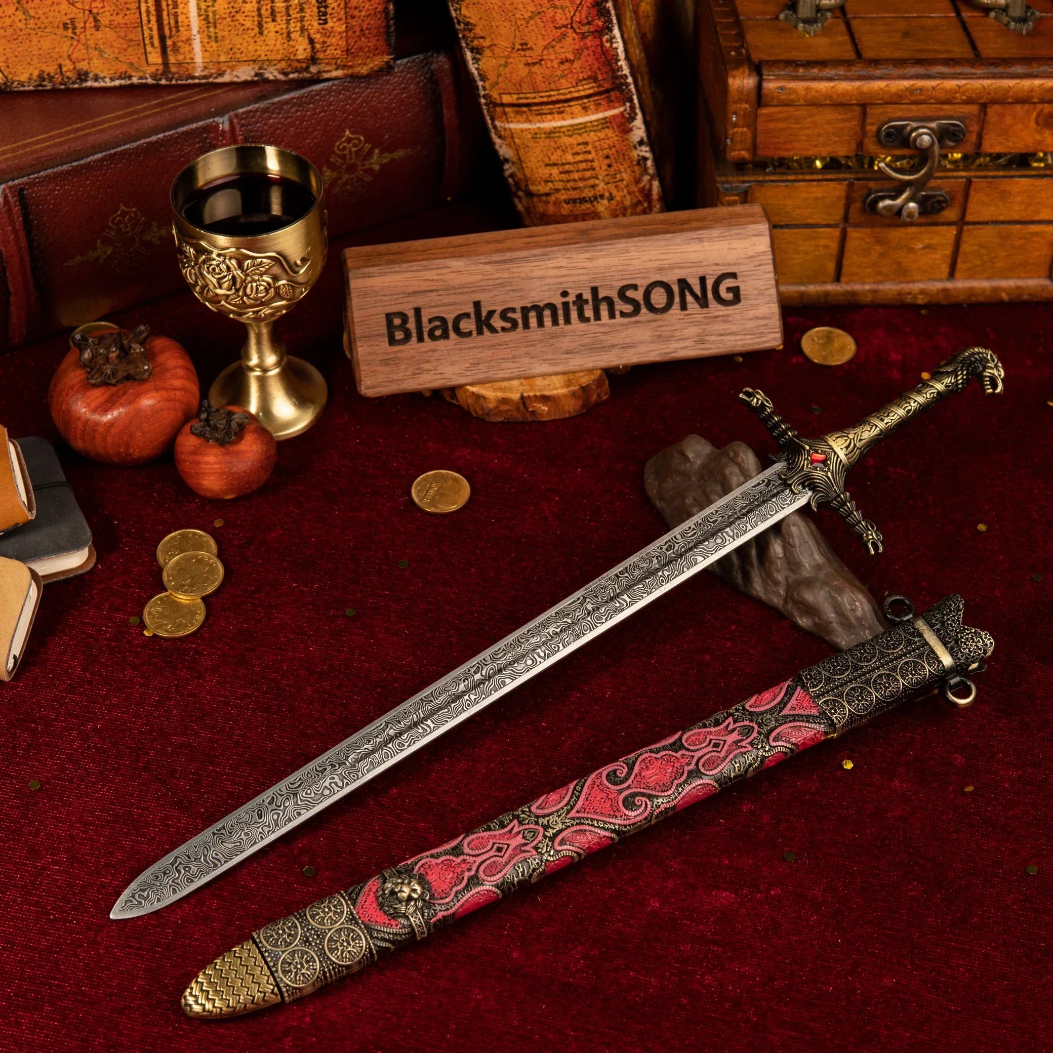 Oathkeeper metal sword replica unsheathed on a red velvet background, surrounded by vintage books, gold coins, and a golden goblet.