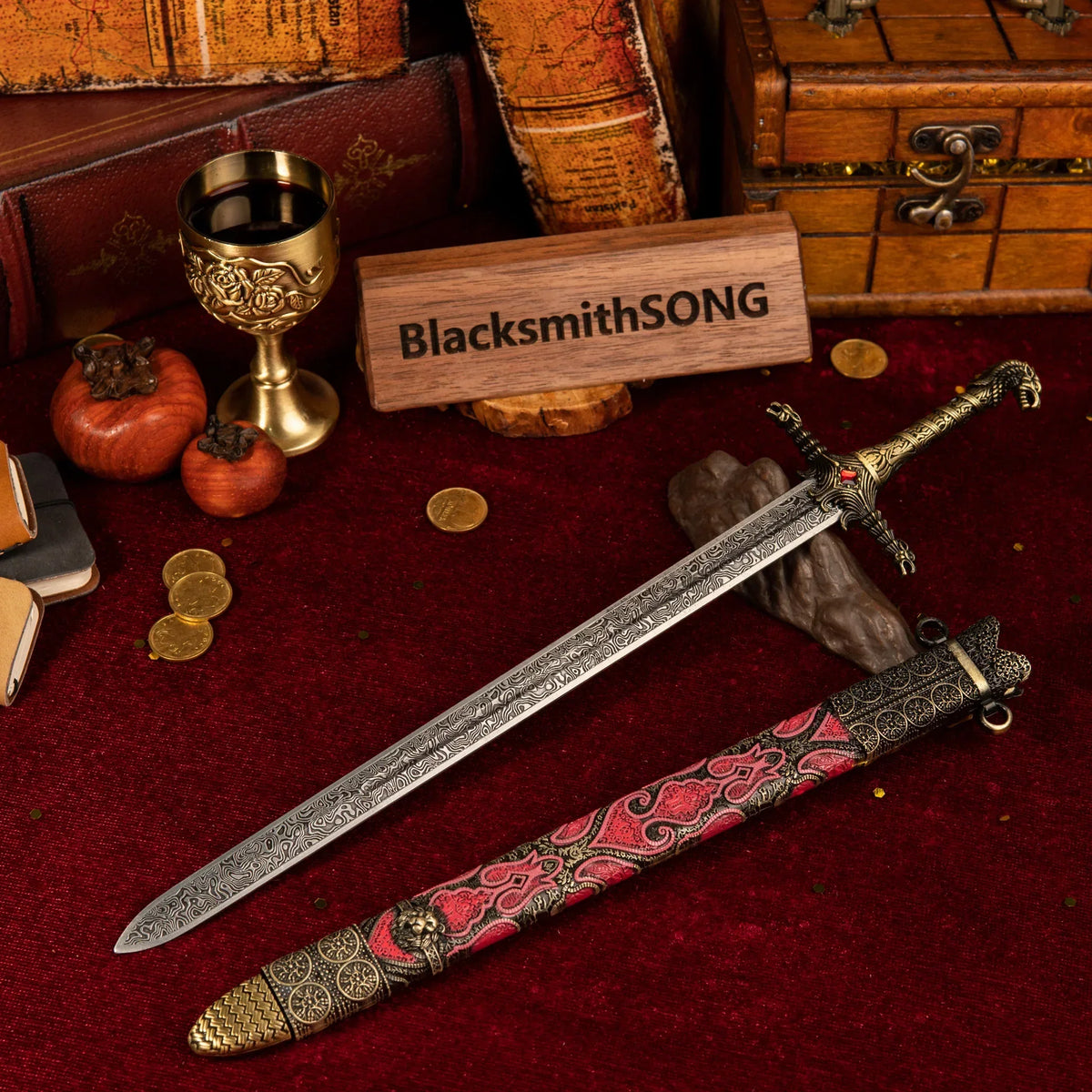 Oathkeeper metal sword replica unsheathed on a red velvet background, surrounded by vintage books, gold coins, and a golden goblet.