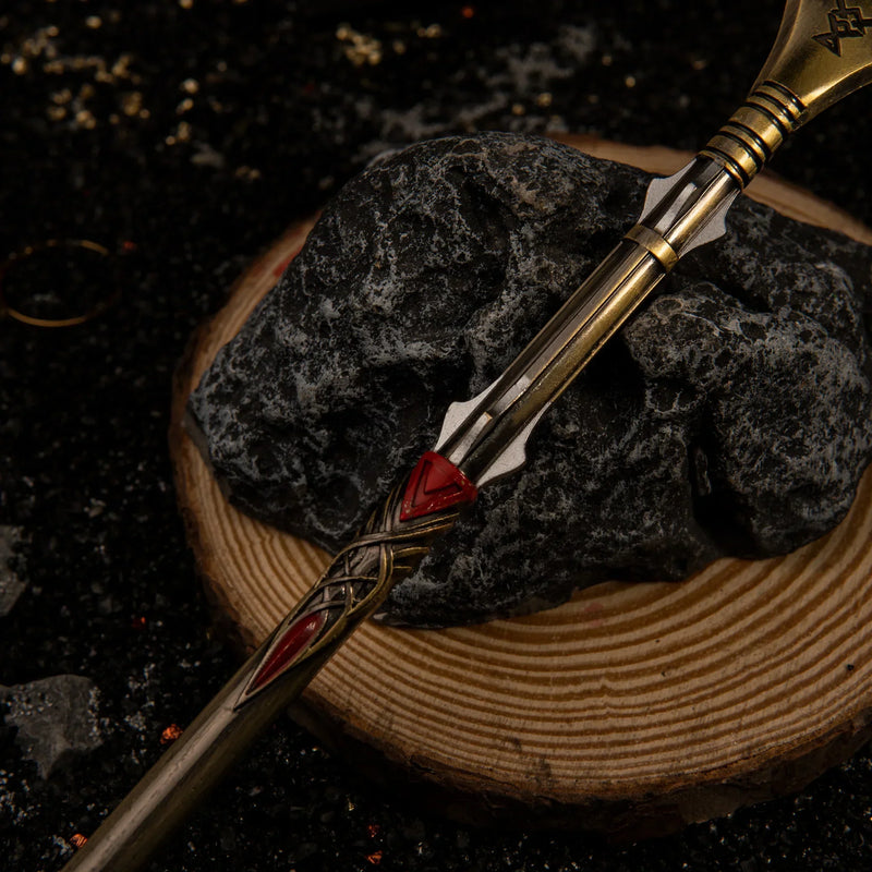 Draupnir Spear replica — full length laid on a wood round, showing the tapered shaft.