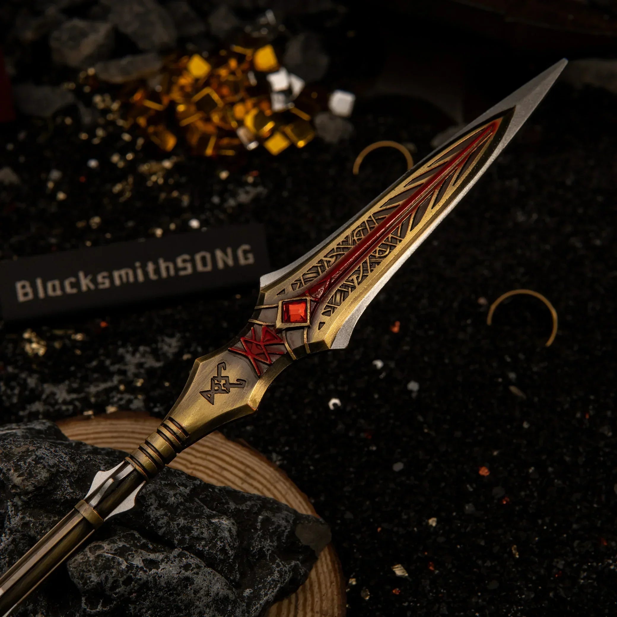 Close up of the Draupnir Spear metal miniature showing intricate Norse engravings and red accents on the spearhead.