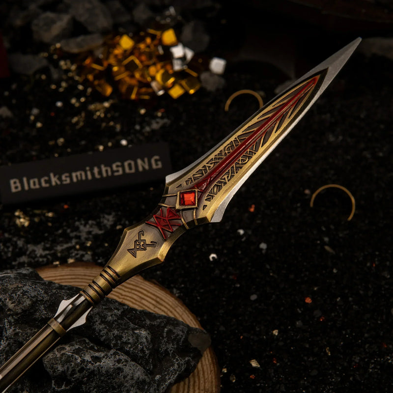 Draupnir Spear replica — spearhead close-up showing the red gem and rune-lined engraving.