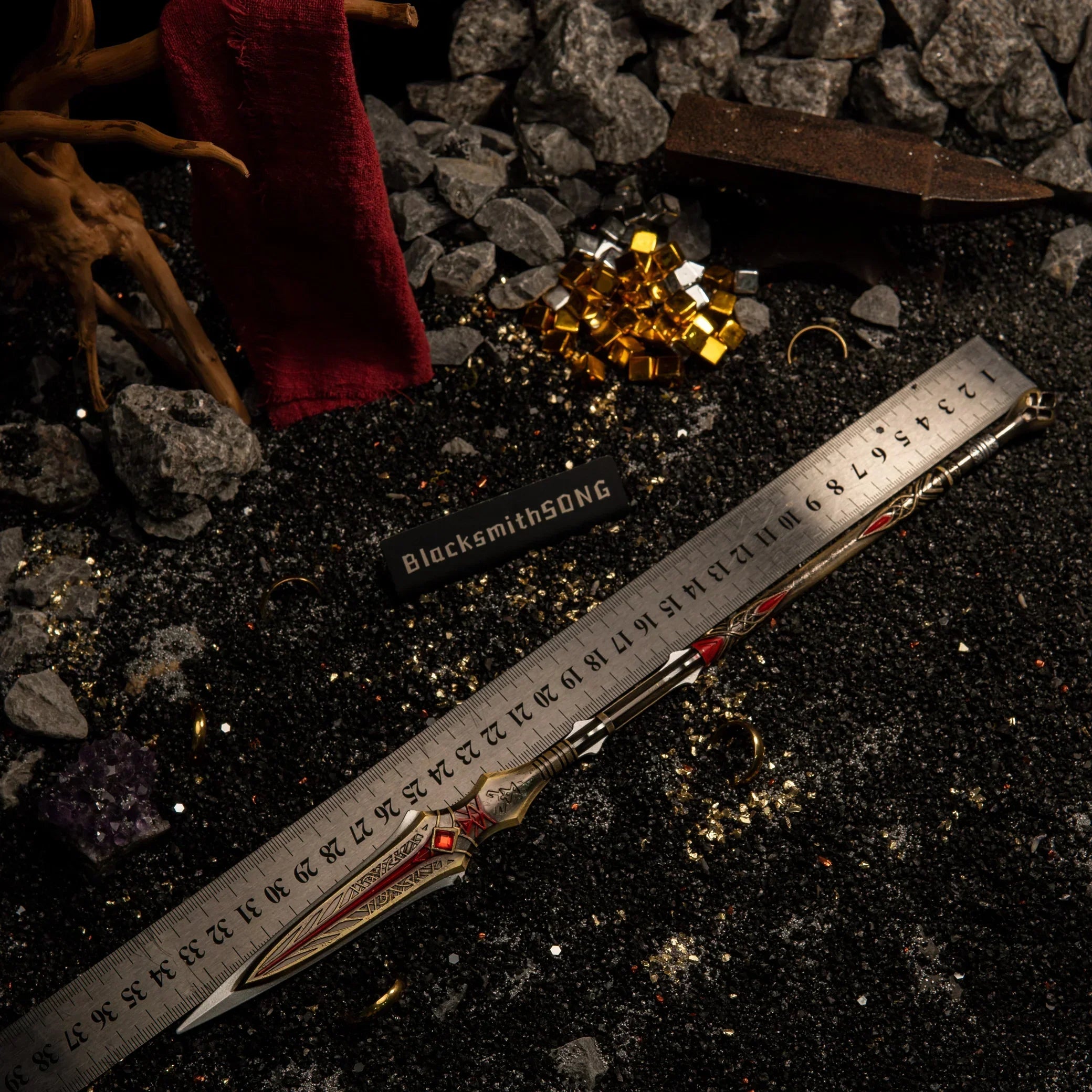 The 35cm Draupnir Spear metal miniature laid next to a ruler to show its exact length.