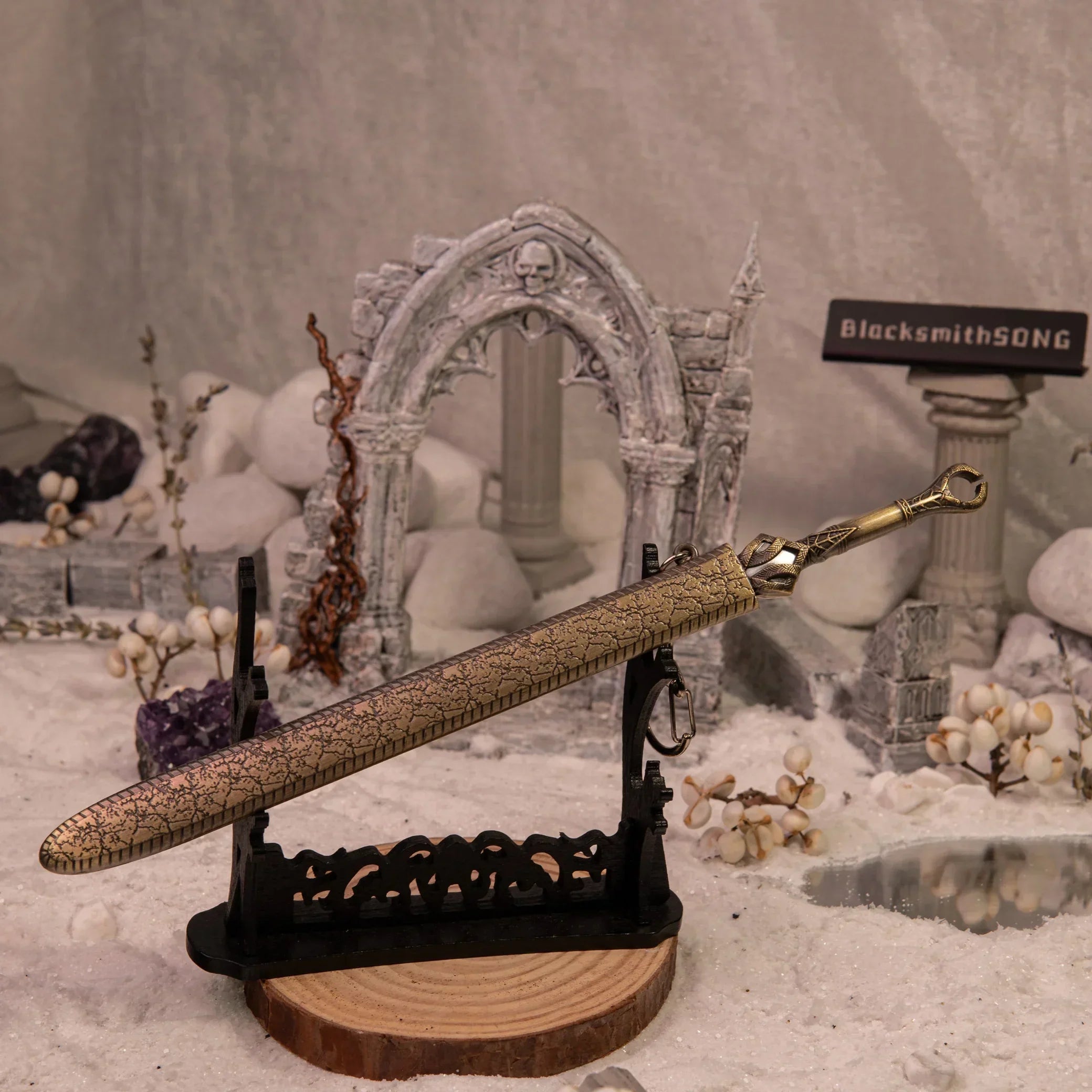 God of War Ingrid metal replica displayed upright on a large stand in a ruins diorama.