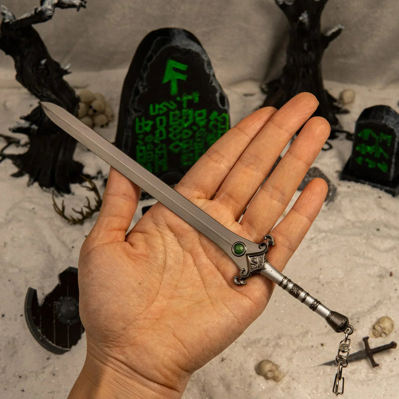 Skofnung replica (22cm die-cast zinc alloy sword) — held in hand for scale.