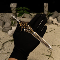 Blade of Olympus replica (21cm die-cast zinc alloy sword) — held in hand for scale.