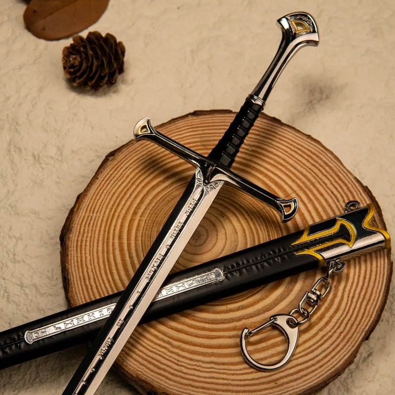 Andúril replica — swept crossguard, gold-accented pommel and ribbed grip on a wood slice.