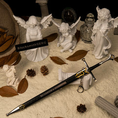 Andúril replica — wider view of the handcrafted angel-shrine set with dry leaves and a stone column.